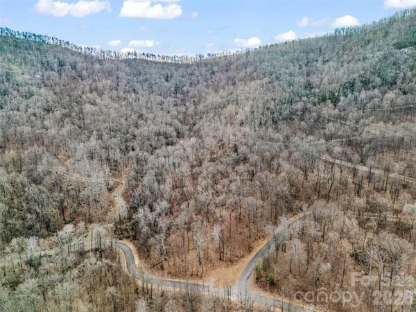 a view of a dry yard with mountains in the background