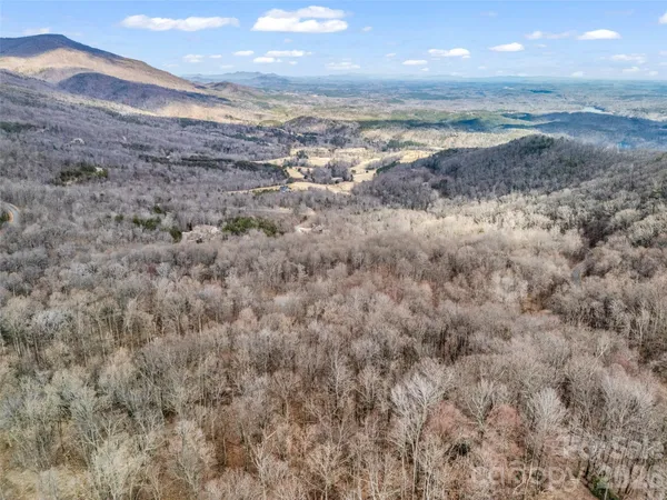 a view of a dry space with mountains in the background