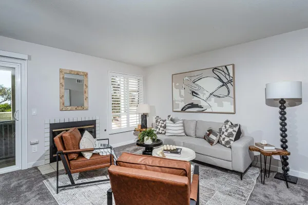 a living room with furniture and a potted plant on table