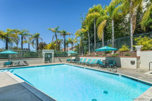 a view of a swimming pool with lounge chairs