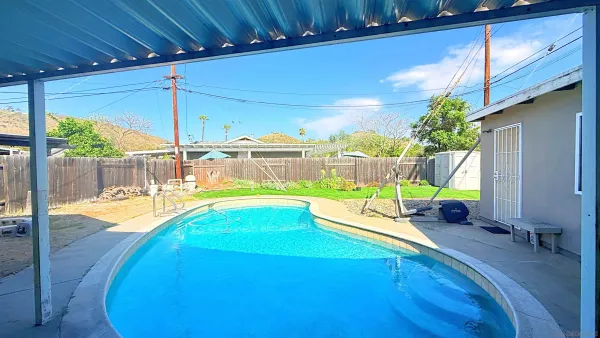 a view of a swimming pool with a patio