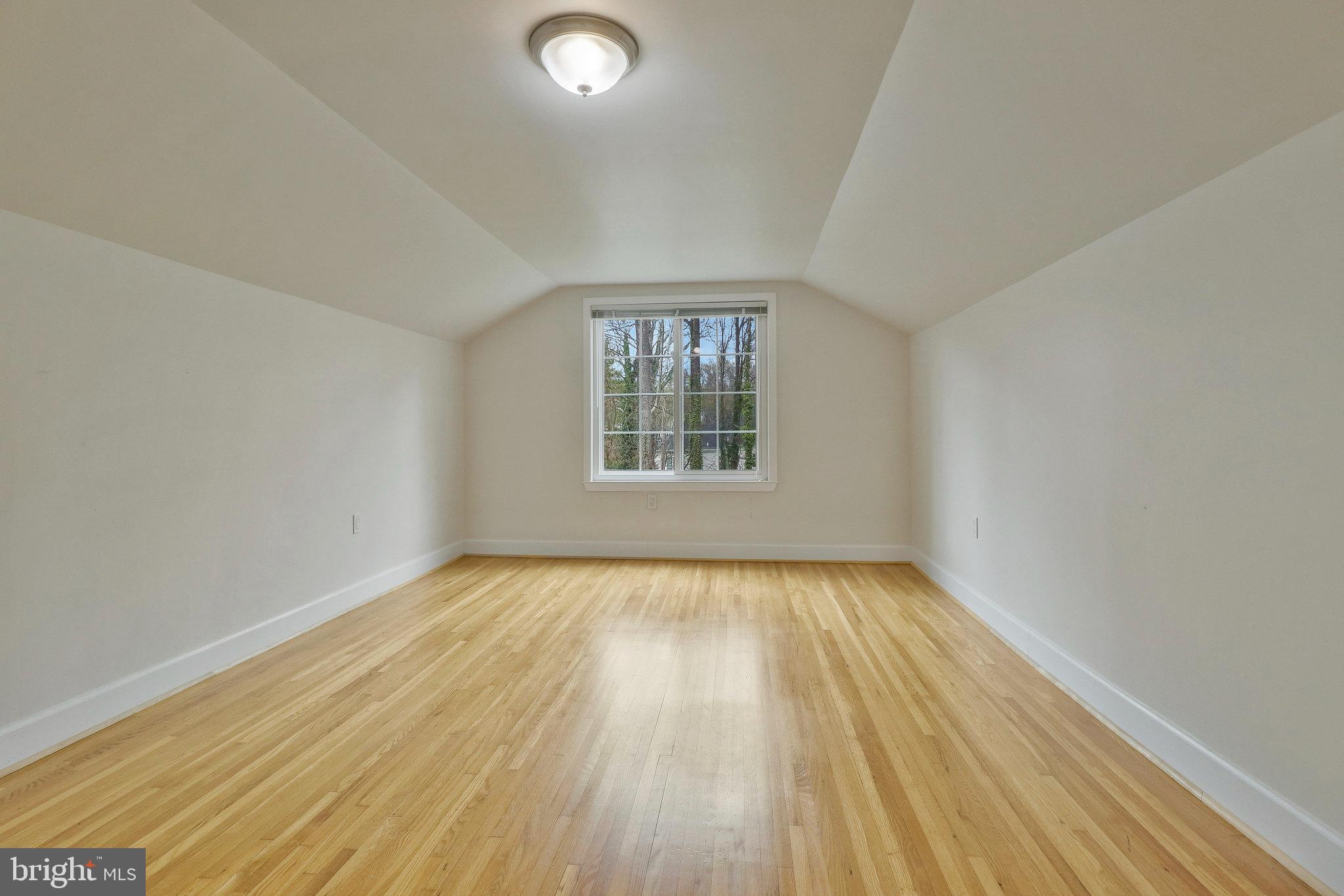 8543 Howell Road Bethesda, MD 20817 - Photo 19 of 24 an empty room with wooden floor window and outdoor view