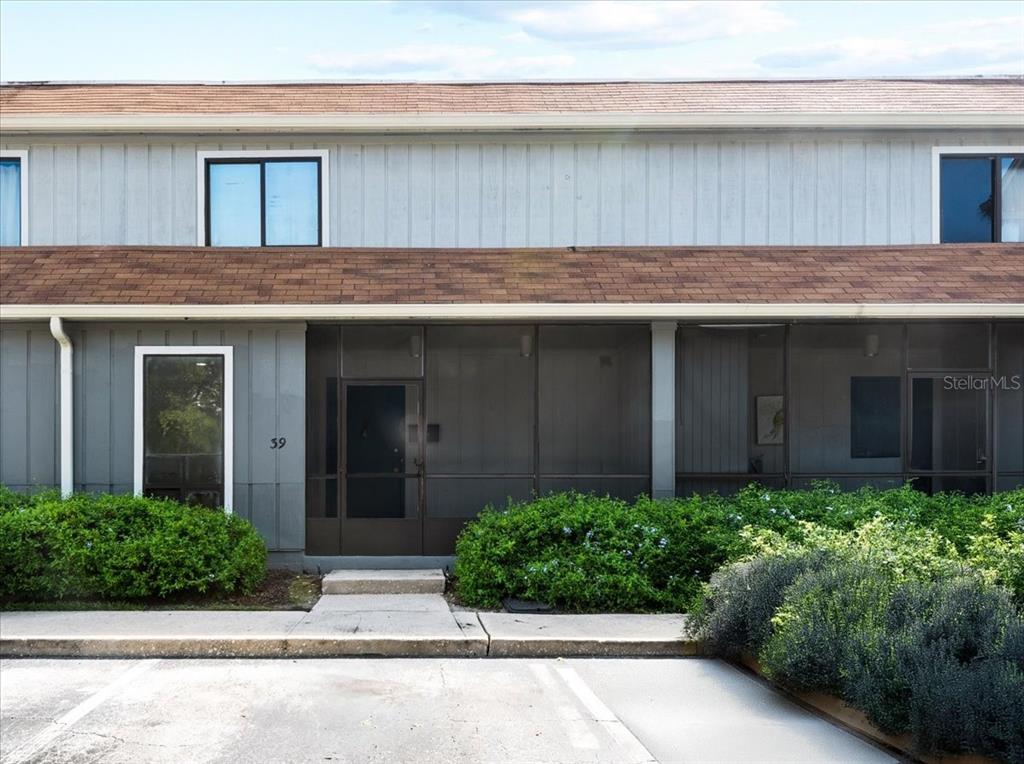 a view of a house with potted plants