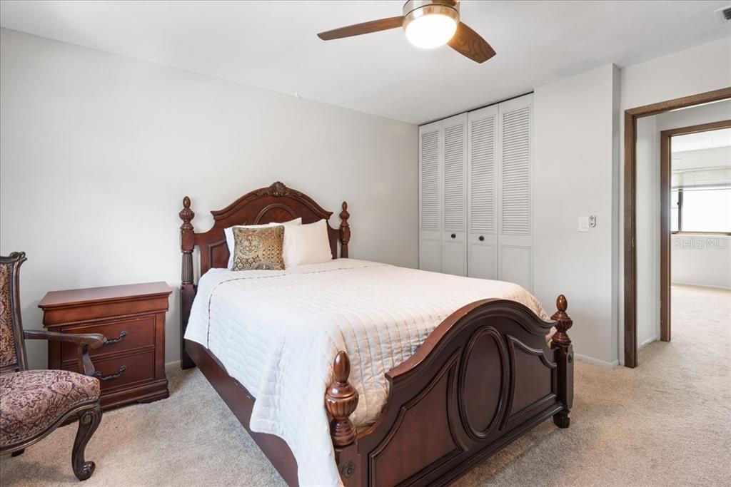 30 Moree Loop, Unit 39 Winter Springs, FL 32708 - Photo 17 of 32 a bedroom with a bed and a chandelier