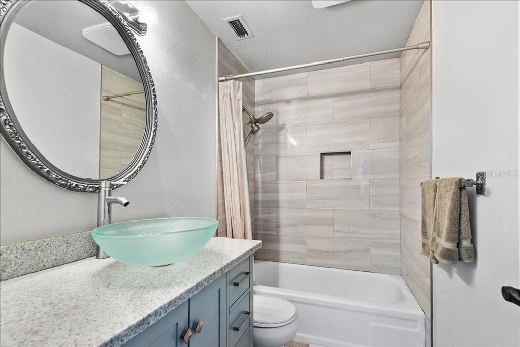 30 Moree Loop, Unit 39 Winter Springs, FL 32708 - Photo 19 of 32 a bathroom with a granite countertop sink a toilet and shower