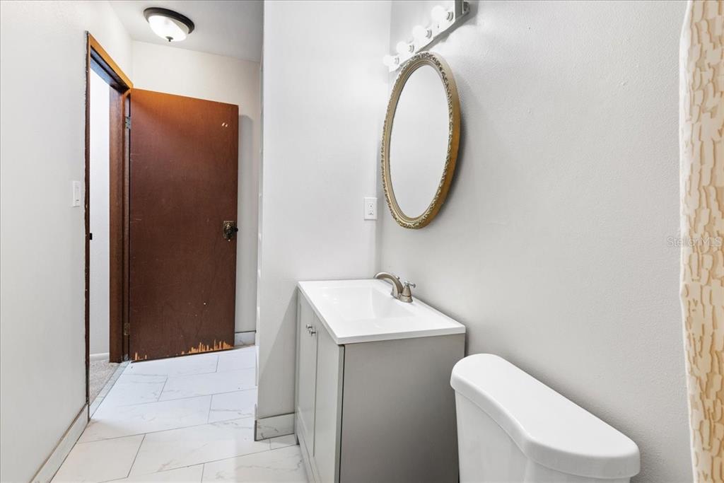 30 Moree Loop, Unit 39 Winter Springs, FL 32708 - Photo 23 of 32 a bathroom with a sink a toilet and a mirror