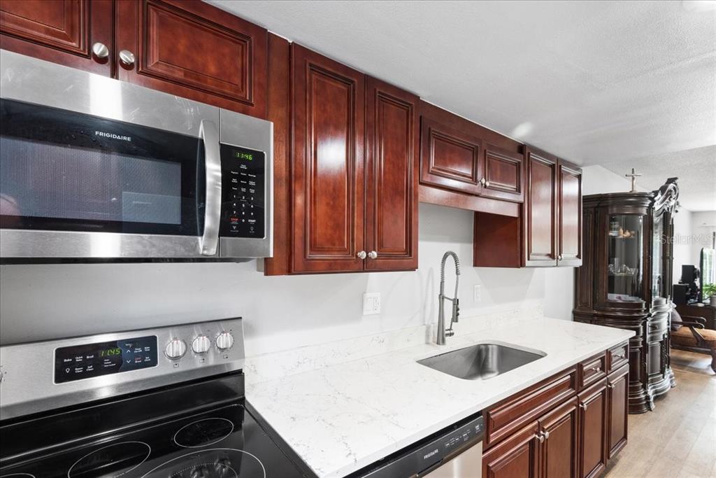 30 Moree Loop, Unit 39 Winter Springs, FL 32708 - Photo 4 of 32 a kitchen with stainless steel appliances granite countertop a sink and a stove