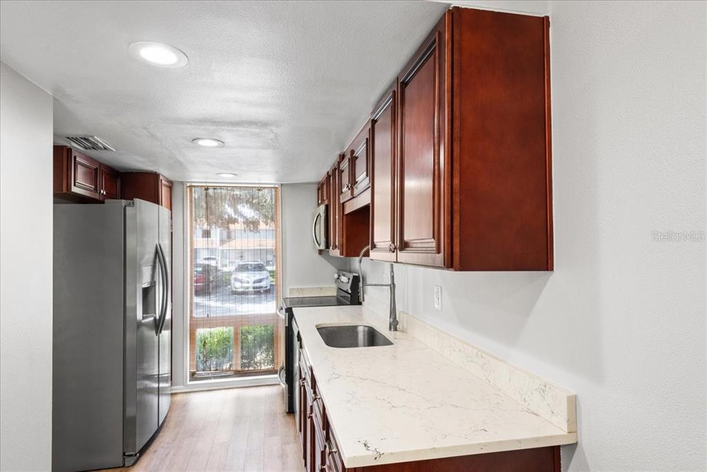 30 Moree Loop, Unit 39 Winter Springs, FL 32708 - Photo 5 of 32 a kitchen with stainless steel appliances a refrigerator and a sink