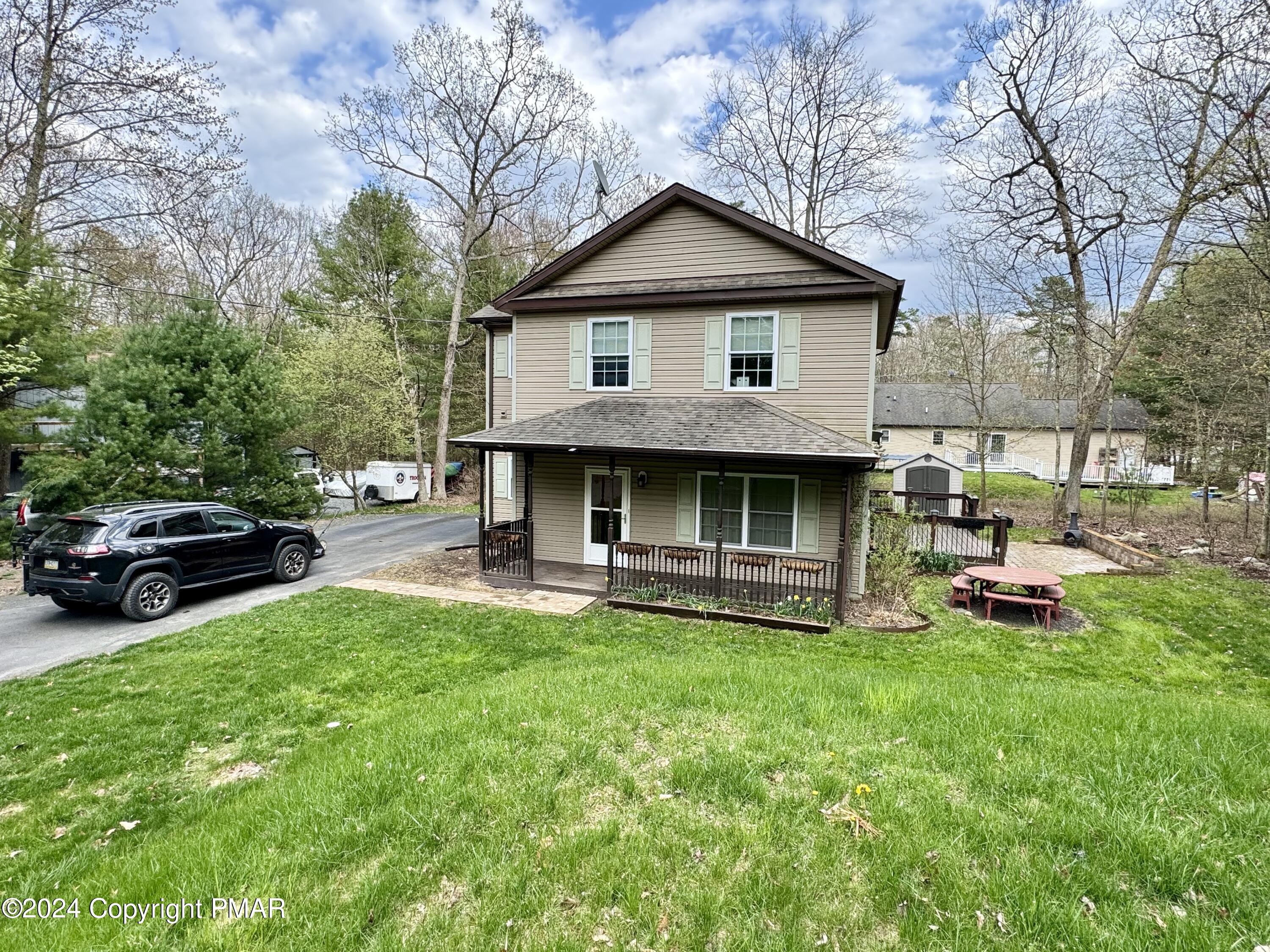 146 Hound Road Dingmans Ferry, PA 18328 - Photo 1 of 50 a view of a house with a yard and sitting area