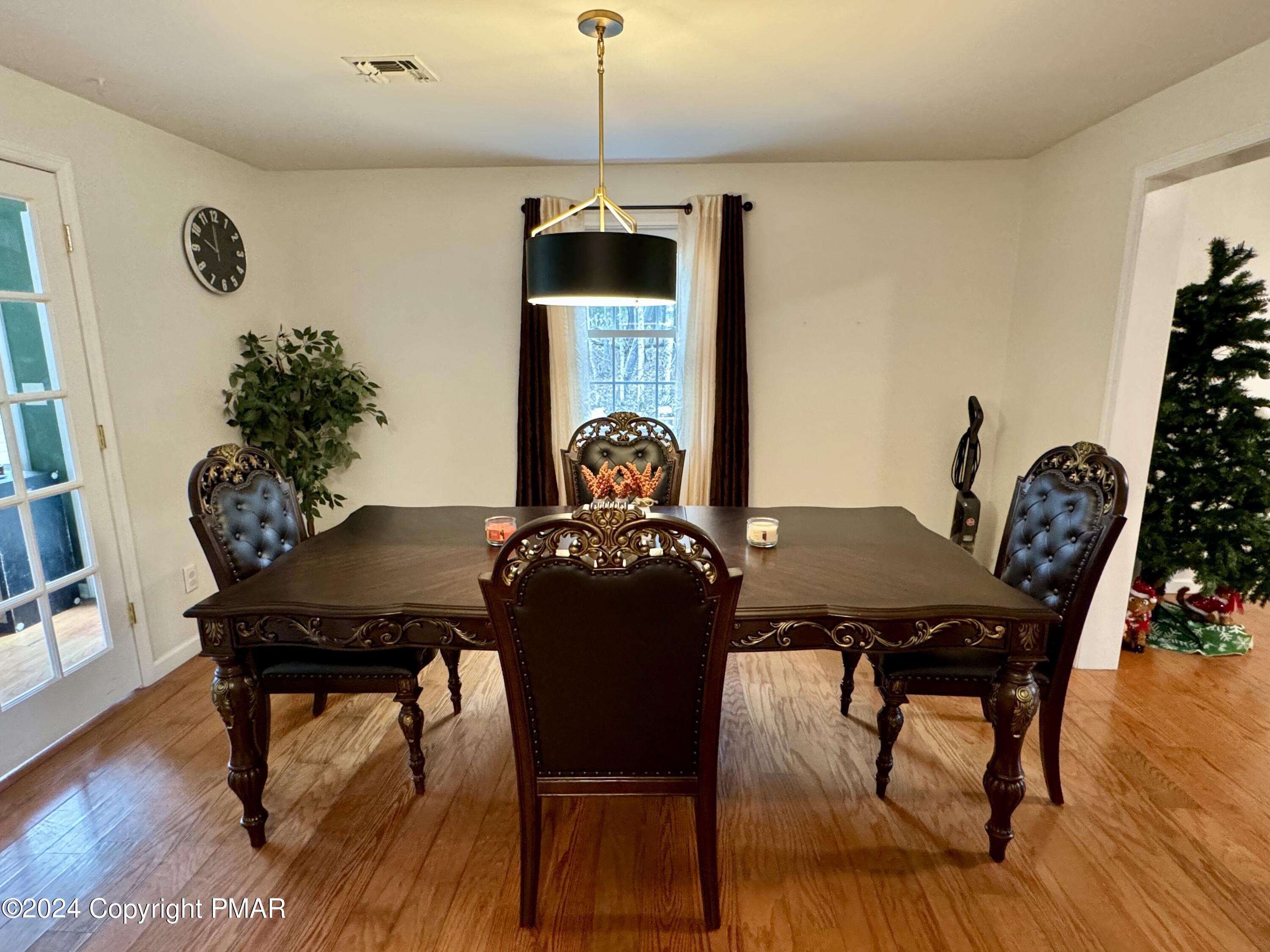 146 Hound Road Dingmans Ferry, PA 18328 - Photo 11 of 50 a view of a dining room with furniture and wooden floor