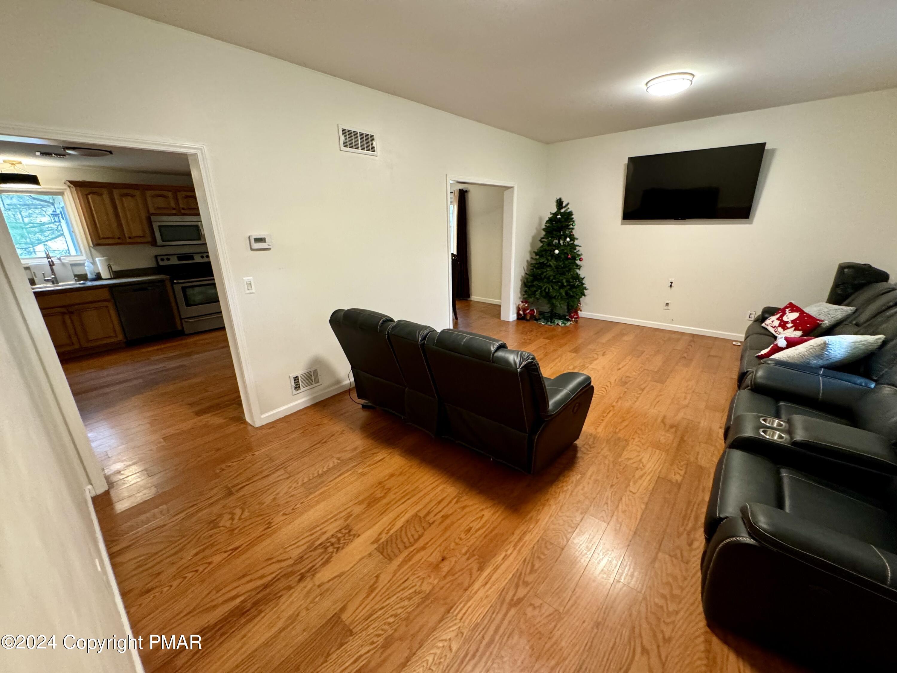 146 Hound Road Dingmans Ferry, PA 18328 - Photo 14 of 50 a living room with furniture and a flat screen tv