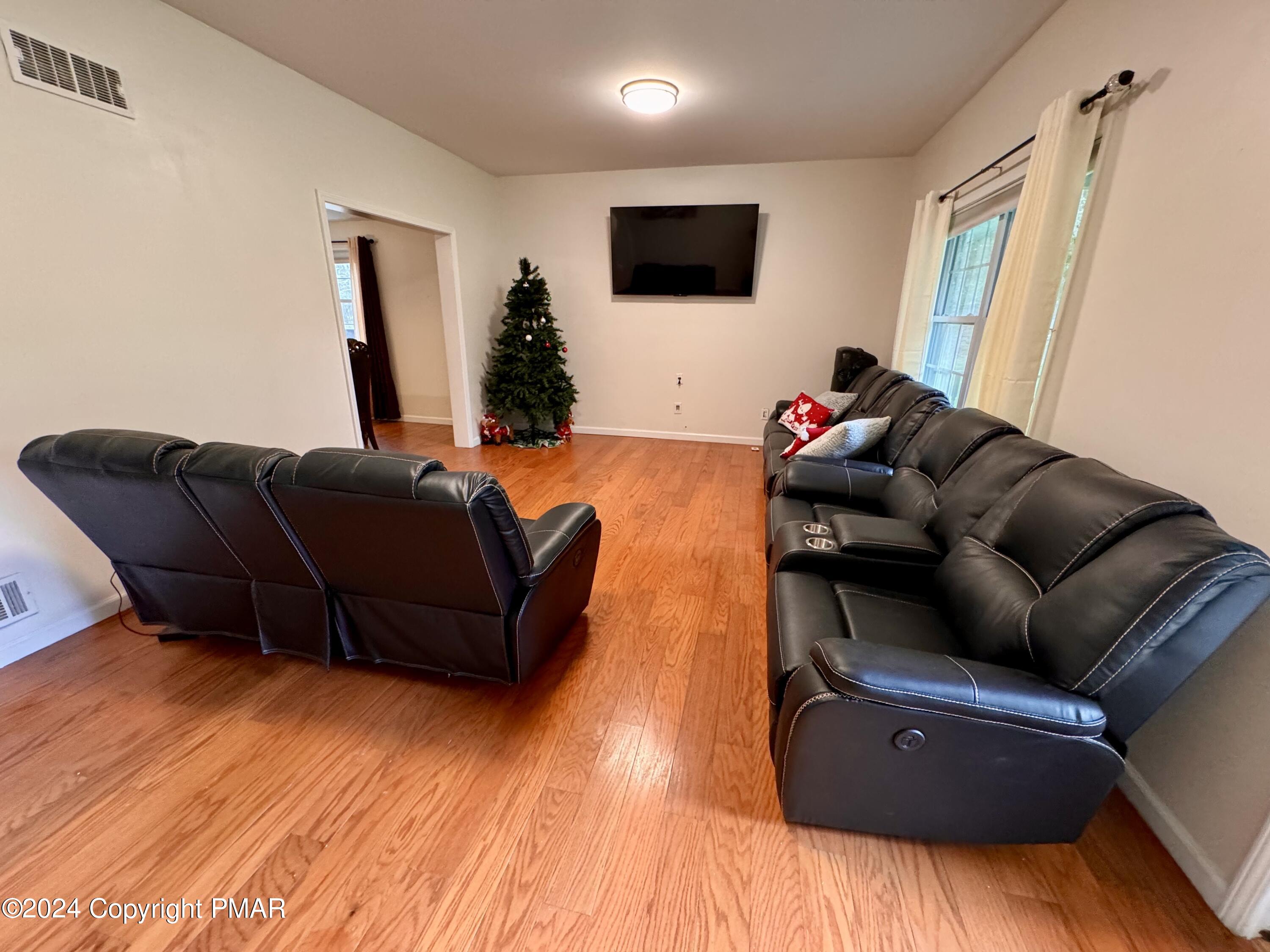 146 Hound Road Dingmans Ferry, PA 18328 - Photo 15 of 50 a living room with furniture and a flat screen tv