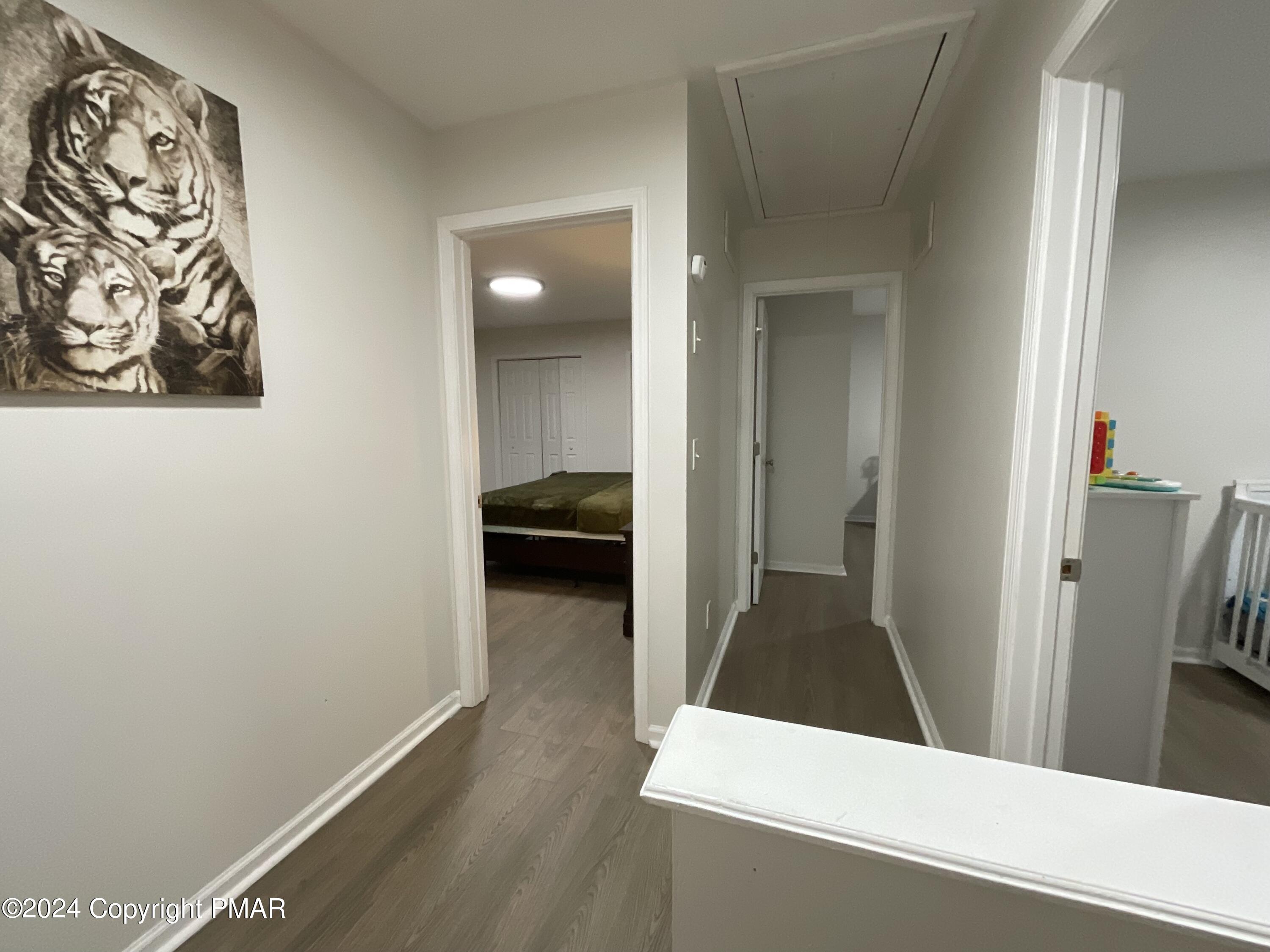 146 Hound Road Dingmans Ferry, PA 18328 - Photo 30 of 50 a view of a hallway and a livingroom with wooden floor
