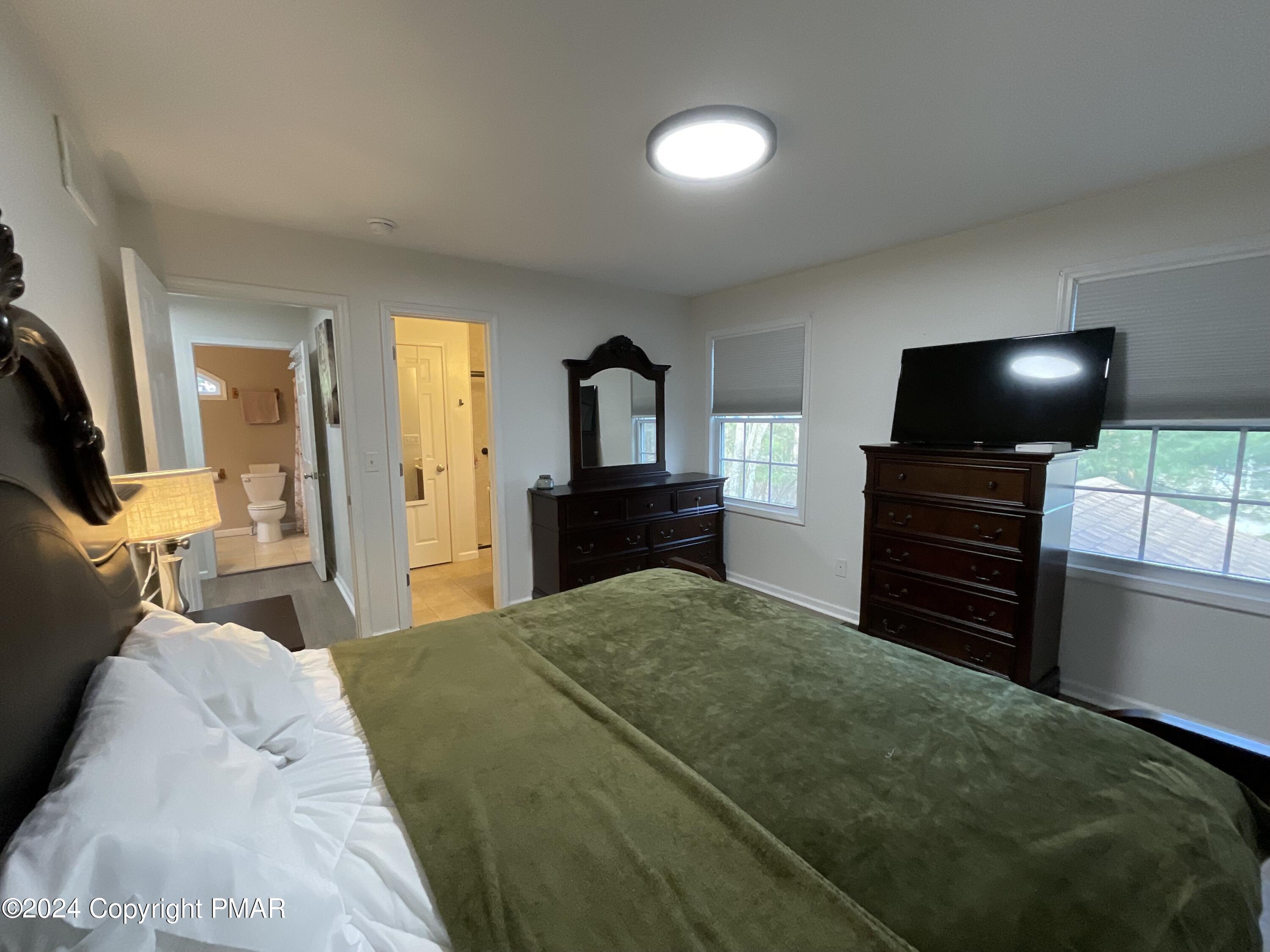 146 Hound Road Dingmans Ferry, PA 18328 - Photo 33 of 50 a bedroom with a bed and furniture