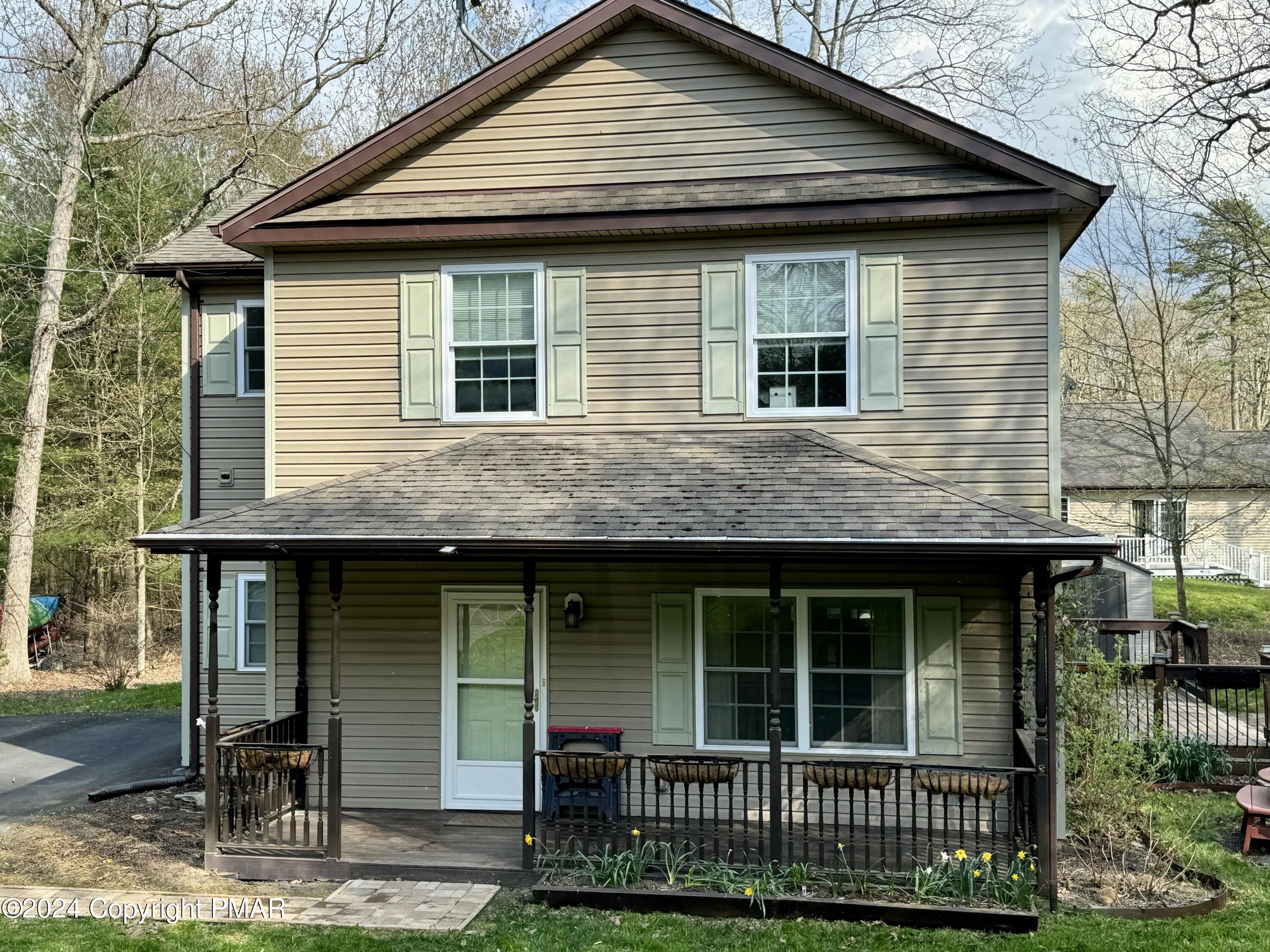 146 Hound Road Dingmans Ferry, PA 18328 - Photo 4 of 50 a front view of a house with a garden