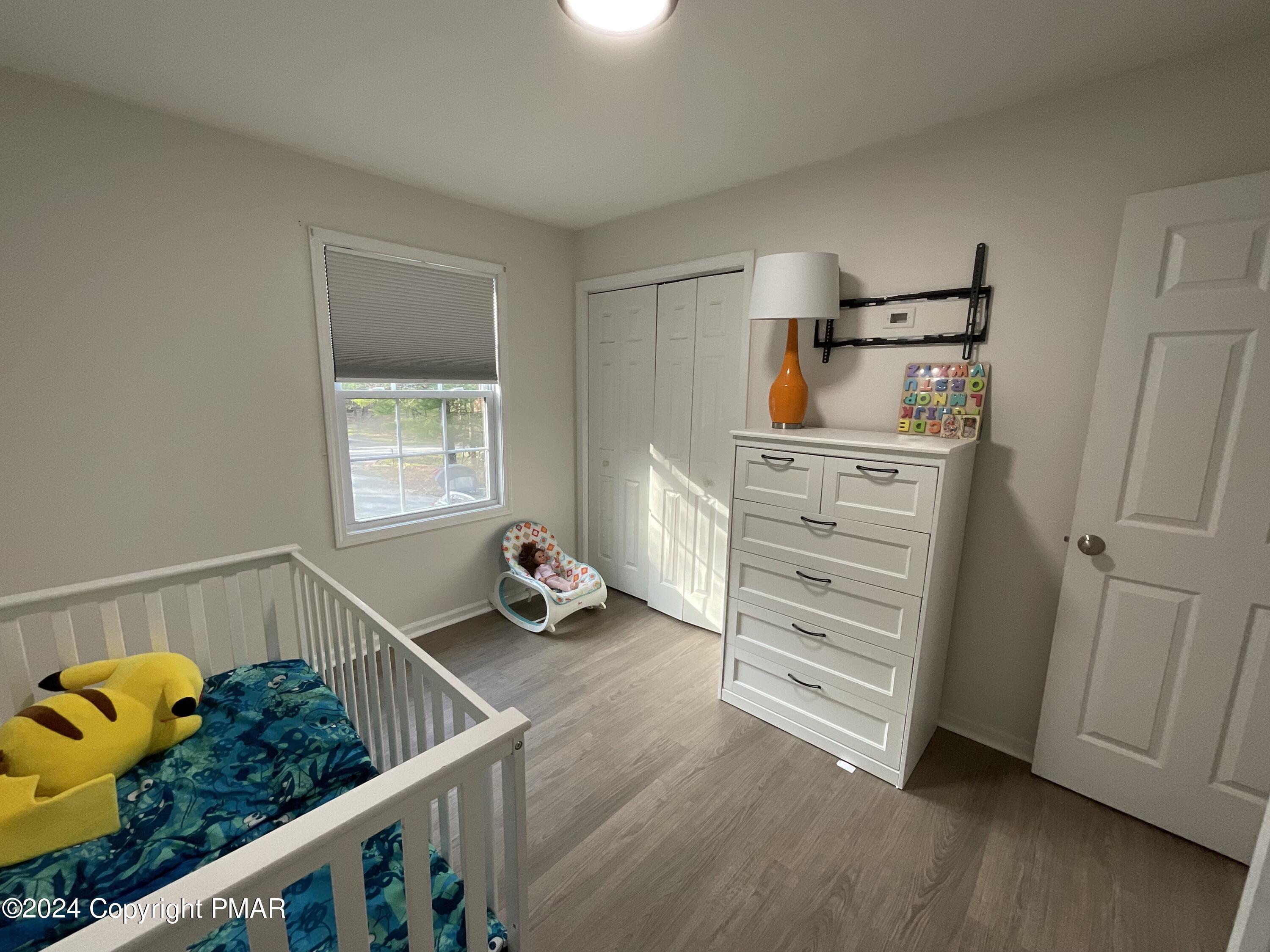 146 Hound Road Dingmans Ferry, PA 18328 - Photo 42 of 50 a view of a bedroom with baby crib and furniture