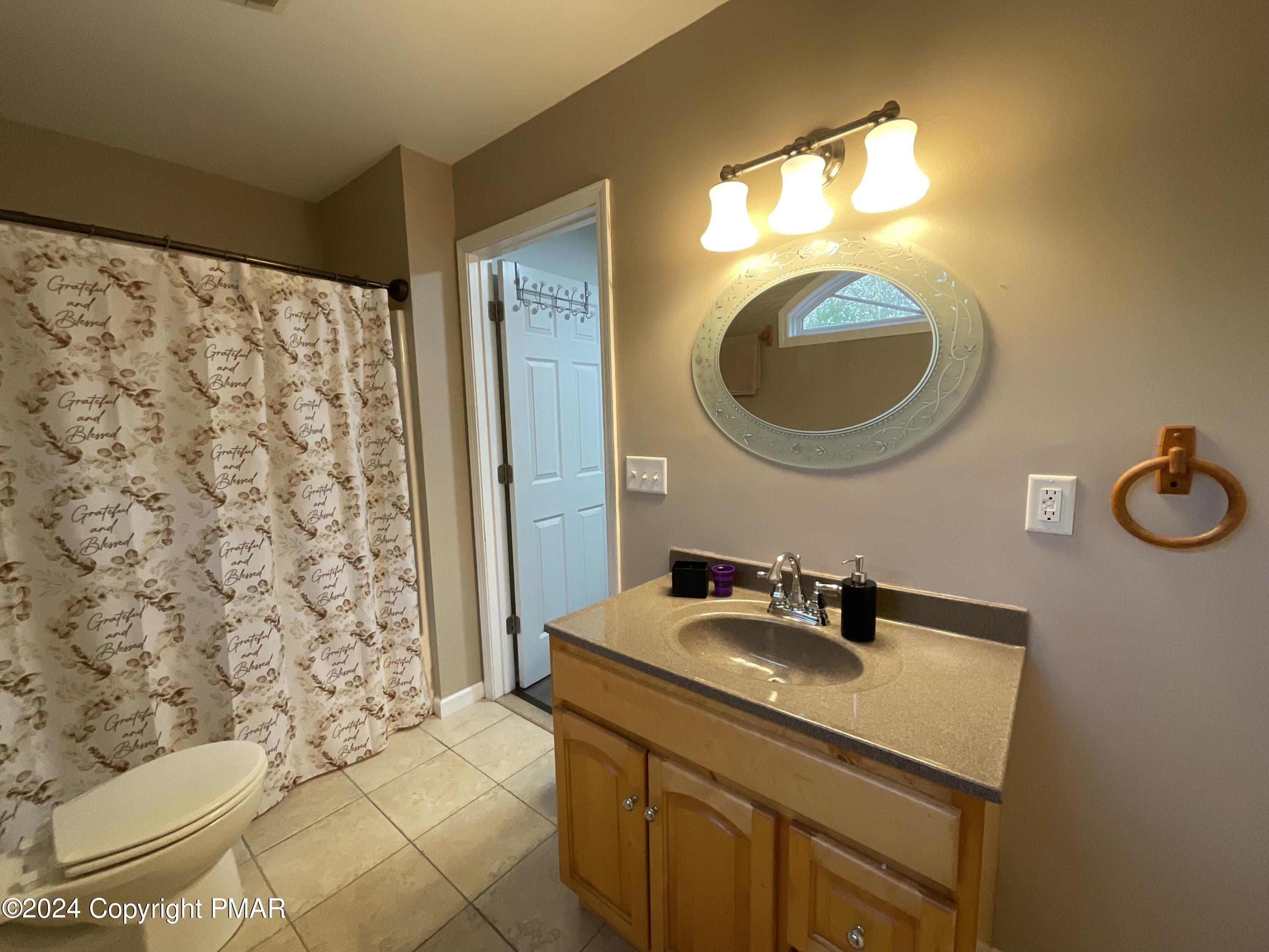 146 Hound Road Dingmans Ferry, PA 18328 - Photo 46 of 50 a bathroom with a sink a toilet and a mirror