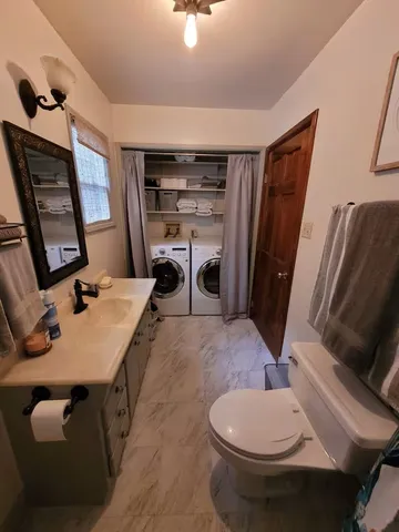 a room with furniture a flat screen tv and a sink