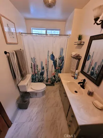 a view of a bathroom with a sink and mirror