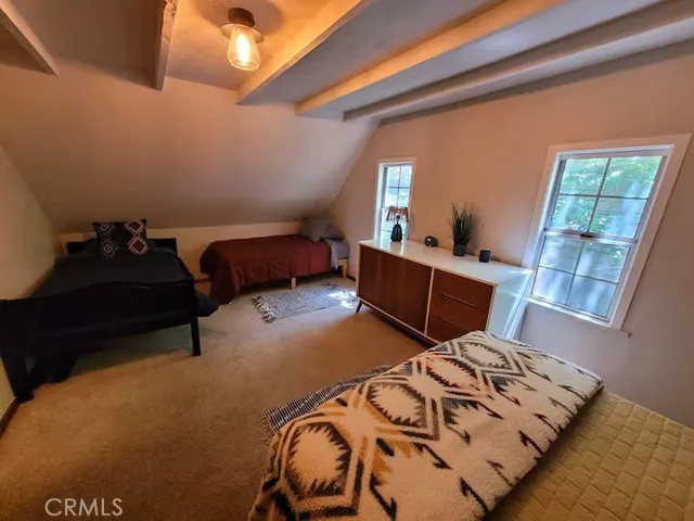 a bedroom with furniture and a window