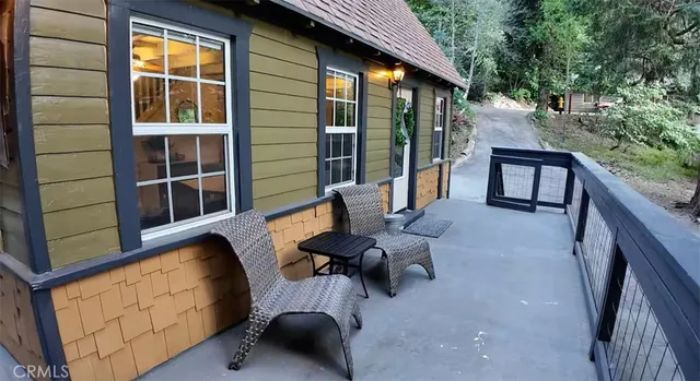 a view of balcony with couch and wooden fence