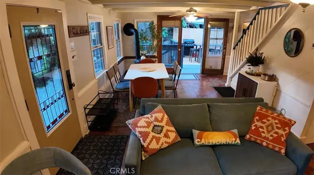 a living room with furniture and a floor to ceiling window