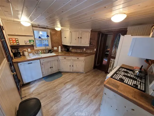 a kitchen with stainless steel appliances granite countertop a stove a sink dishwasher and a refrigerator