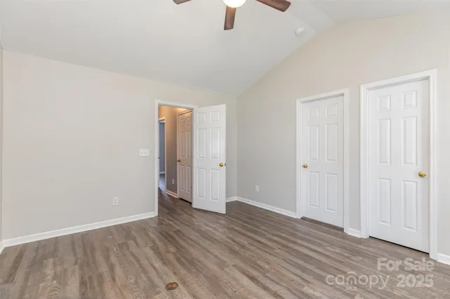 a view of livingroom with front door and wooden floor