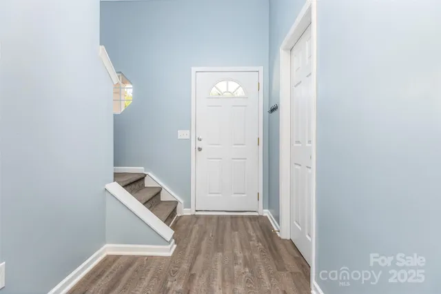 a view of front door with wooden floor
