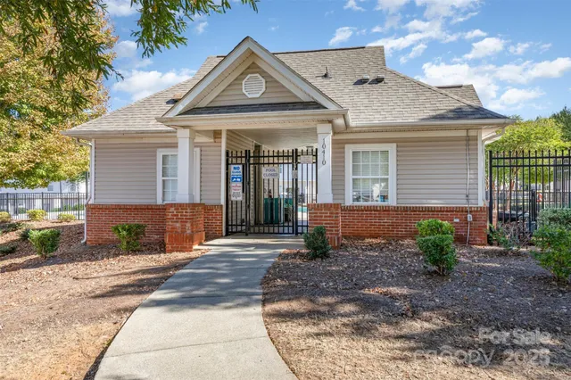a view of a white house next to a yard