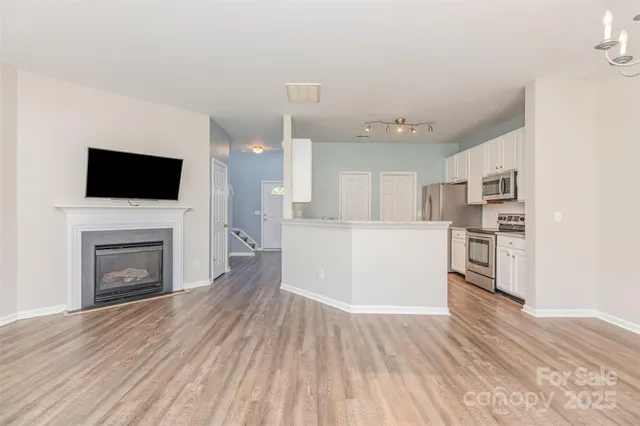 a kitchen with cabinets stainless steel appliances and a window