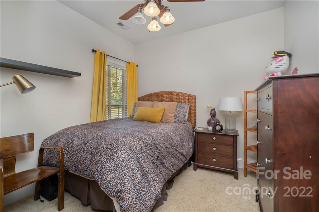 2738 Reservation Road Rock Hill, SC 29730 - Photo 13 of 28 a bedroom with a bed and a chandelier