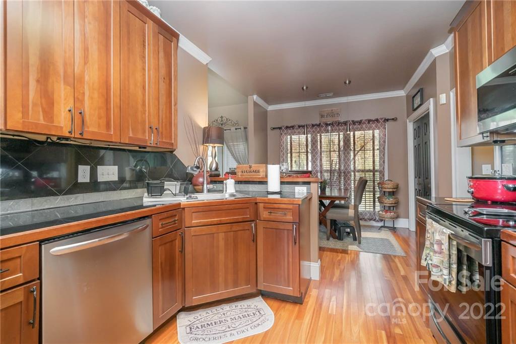 2738 Reservation Road Rock Hill, SC 29730 - Photo 16 of 28 a kitchen with stainless steel appliances granite countertop a refrigerator a sink dishwasher a stove and white countertops with wooden floor