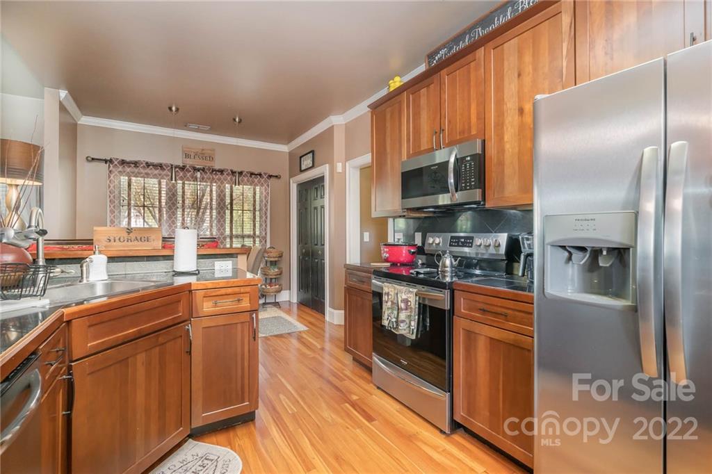 2738 Reservation Road Rock Hill, SC 29730 - Photo 18 of 28 a kitchen with stainless steel appliances granite countertop a refrigerator a stove and a sink with wooden floors