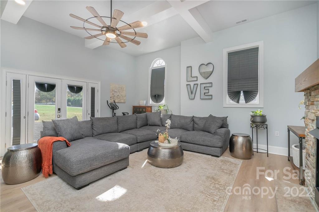 2738 Reservation Road Rock Hill, SC 29730 - Photo 7 of 28 a living room with furniture a chandelier and a large mirror