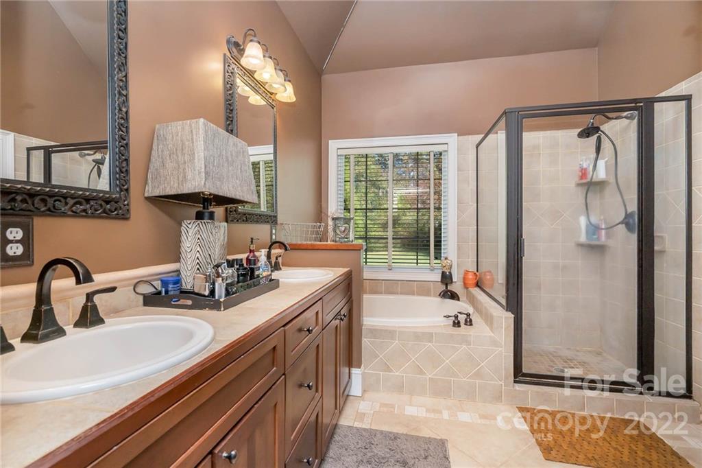 2738 Reservation Road Rock Hill, SC 29730 - Photo 10 of 28 a bathroom with a double vanity sink a mirror and a bathtub