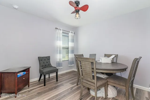 a view of a dining room with furniture and wooden floor