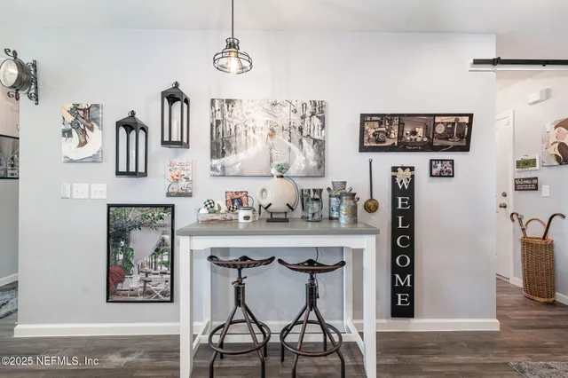 a view of a kitchen area with furniture and wooden floor