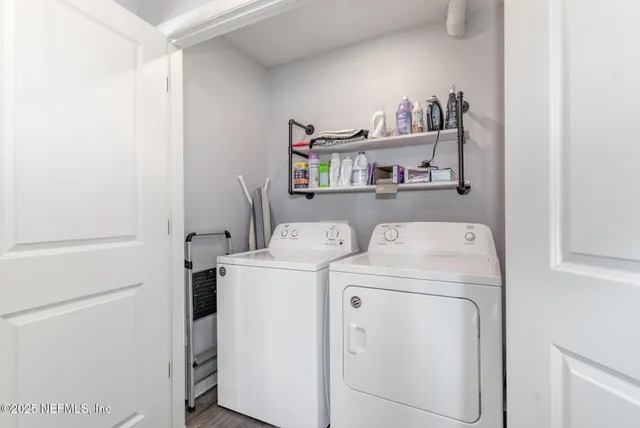 a view of storage and utility room with washer and dryer