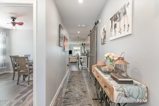 a dining room with furniture and wooden floor