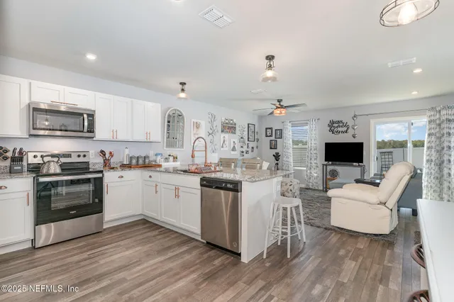 a kitchen with sink cabinets and wooden floor