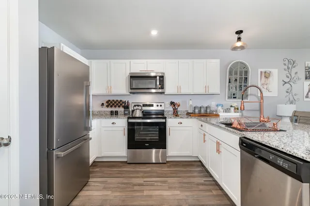 a kitchen with a refrigerator stove and sink