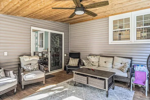 a outdoor living space with a couch and chairs