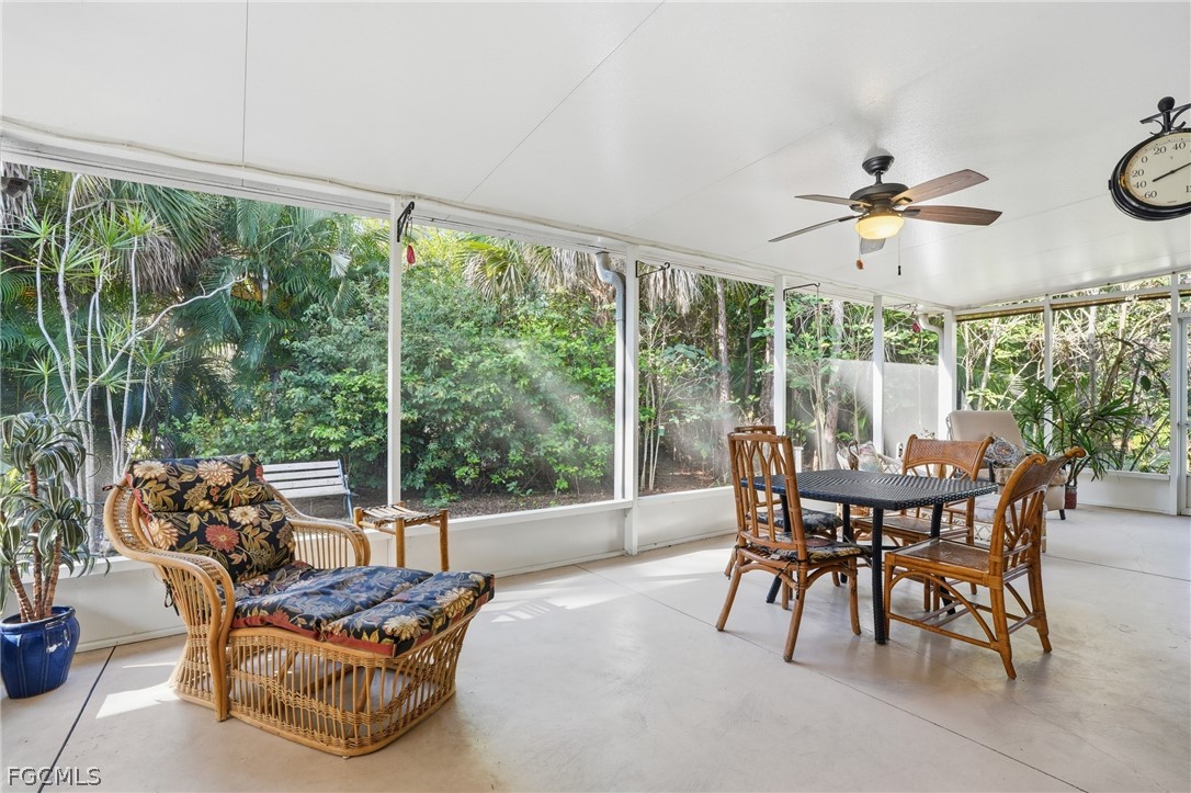 10730 Rio Mar Circle Estero, FL 33928 - Photo 24 of 47 a dining room with furniture water view and a floor to ceiling window