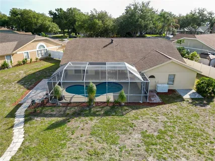 a view of a house with a yard and sitting area