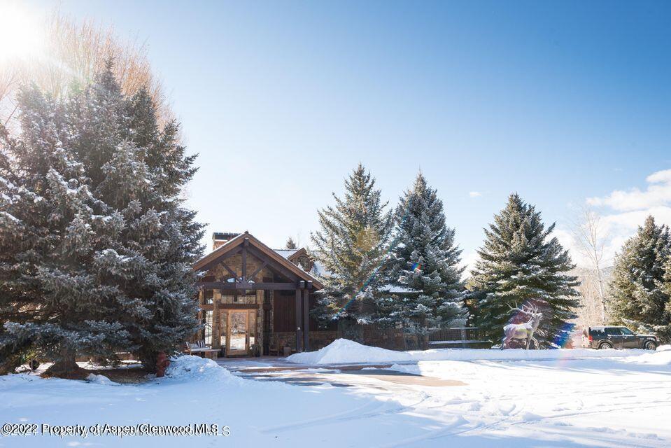 38 Diamond A Ranch Road Carbondale, CO 81623 - Photo 4 of 44 a front view of a house with a yard covered in snow