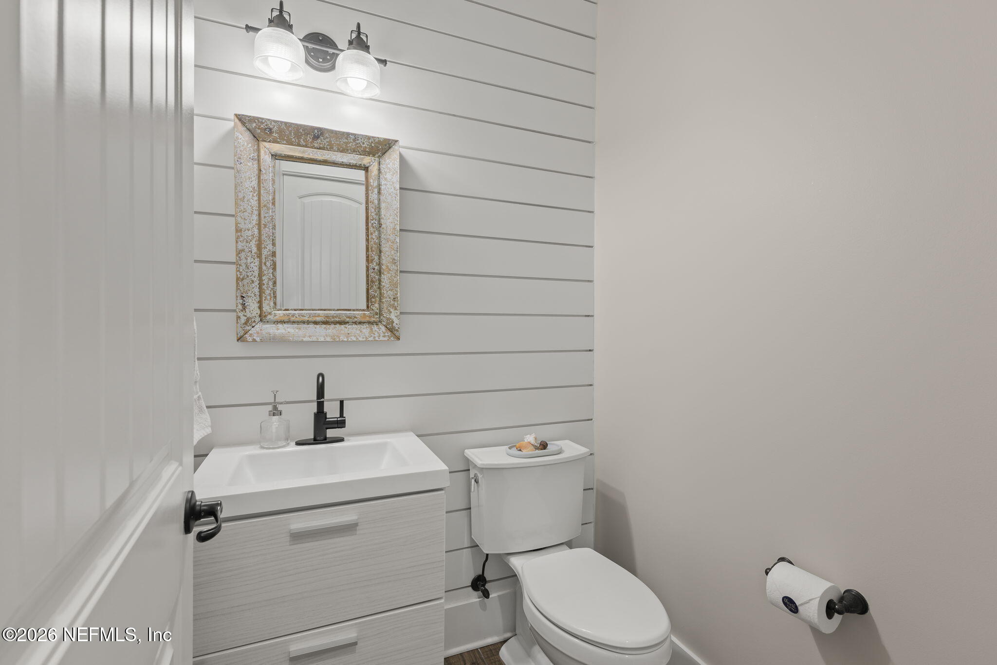 599 Timber Bridge Lane Atlantic Beach, FL 32233 - Photo 20 of 60 a bathroom with a toilet sink and mirror