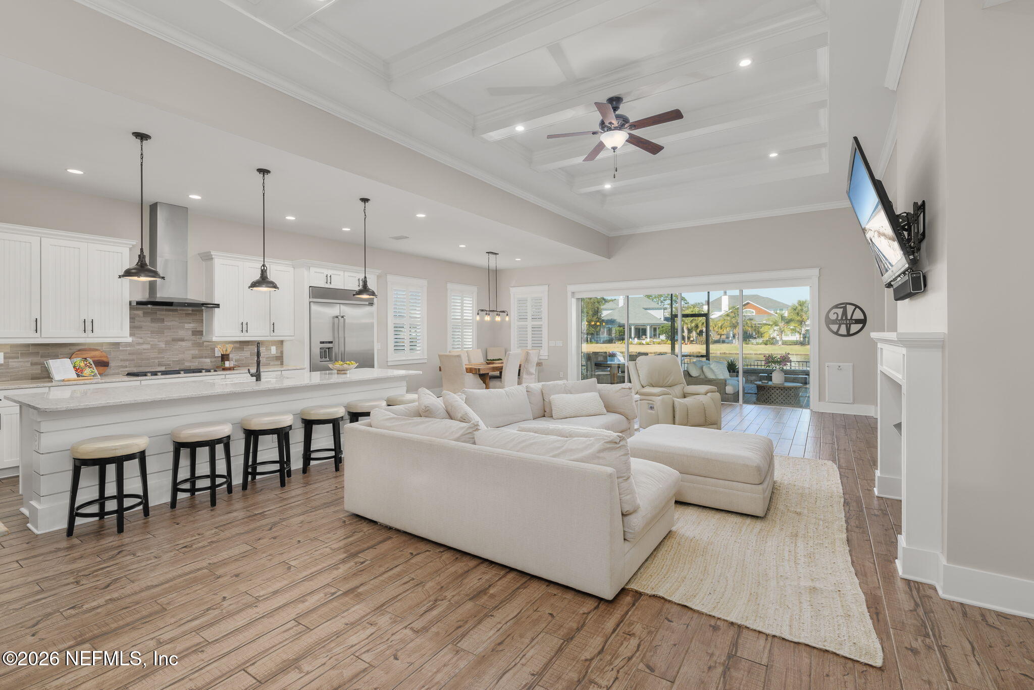 599 Timber Bridge Lane Atlantic Beach, FL 32233 - Photo 2 of 60 a large white kitchen with stainless steel appliances granite countertop a stove refrigerator a dining table and chairs with wooden floor