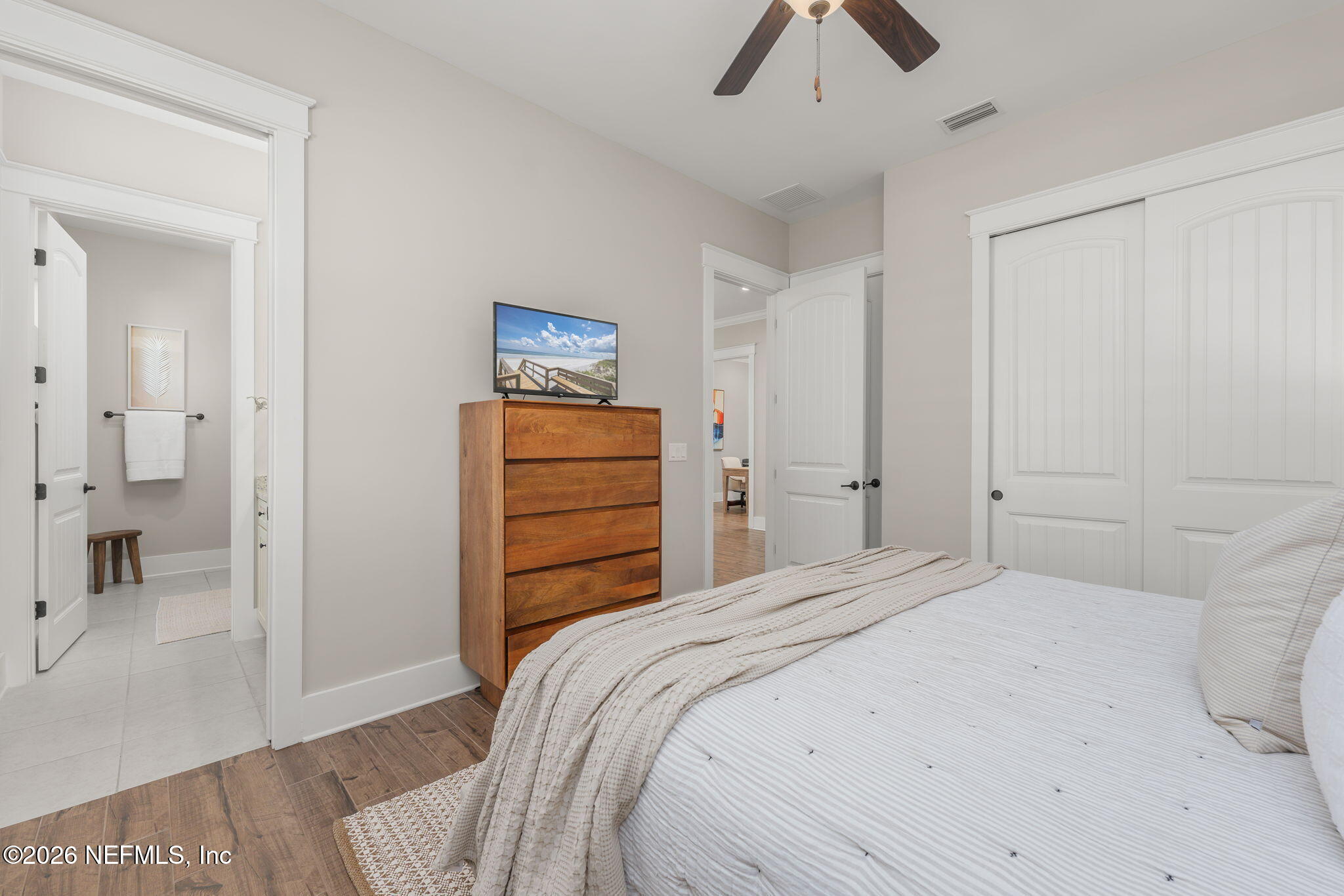 599 Timber Bridge Lane Atlantic Beach, FL 32233 - Photo 23 of 60 a bedroom with a bed and a chandelier