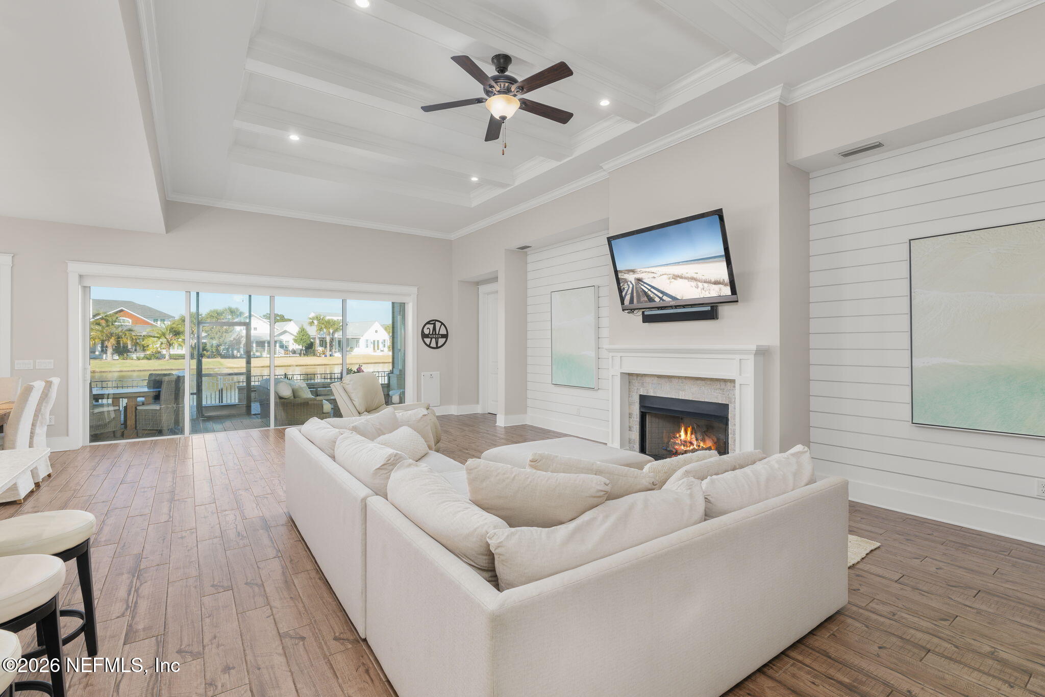 599 Timber Bridge Lane Atlantic Beach, FL 32233 - Photo 26 of 60 a living room with furniture a fireplace and a floor to ceiling window
